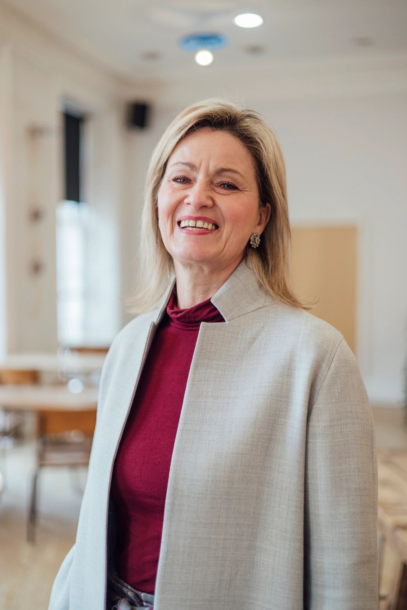 Portrait of a smiling professional woman in a café setting