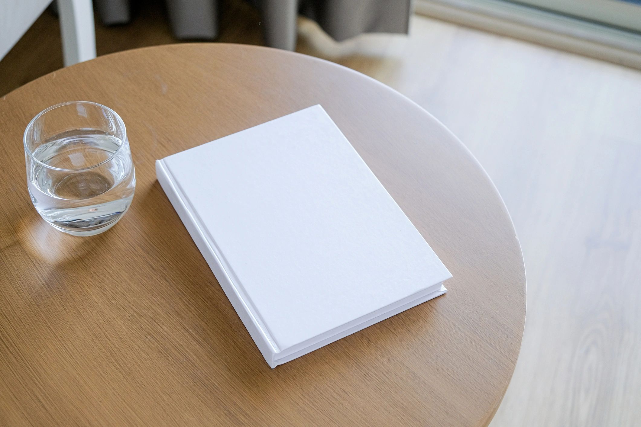 Book mockup on a wooden coffee table